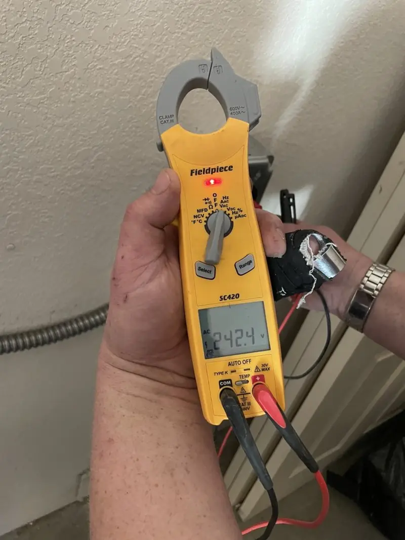 Voltage testing with clamp meter during Electrical Installation Services in Stamford
